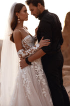 Nabila bridal veil with soft floral accents, enhancing a lace-sleeved wedding dress for an elegant look.