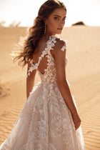 The Wisteria bridal dress with floral lace details and sheer back adds romantic sophistication.
