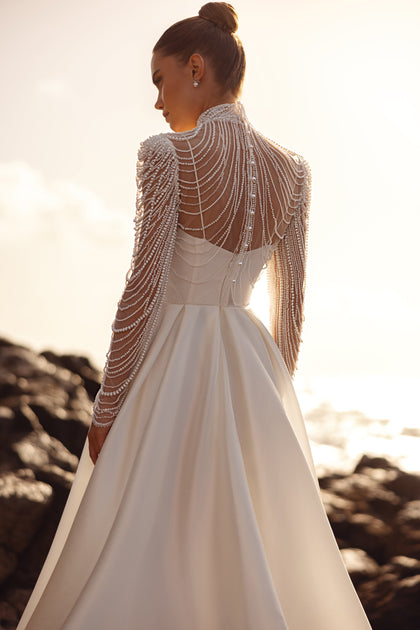 Alya bridal blouse with long sleeves and dramatic pearl back design offers breathtaking elegance.