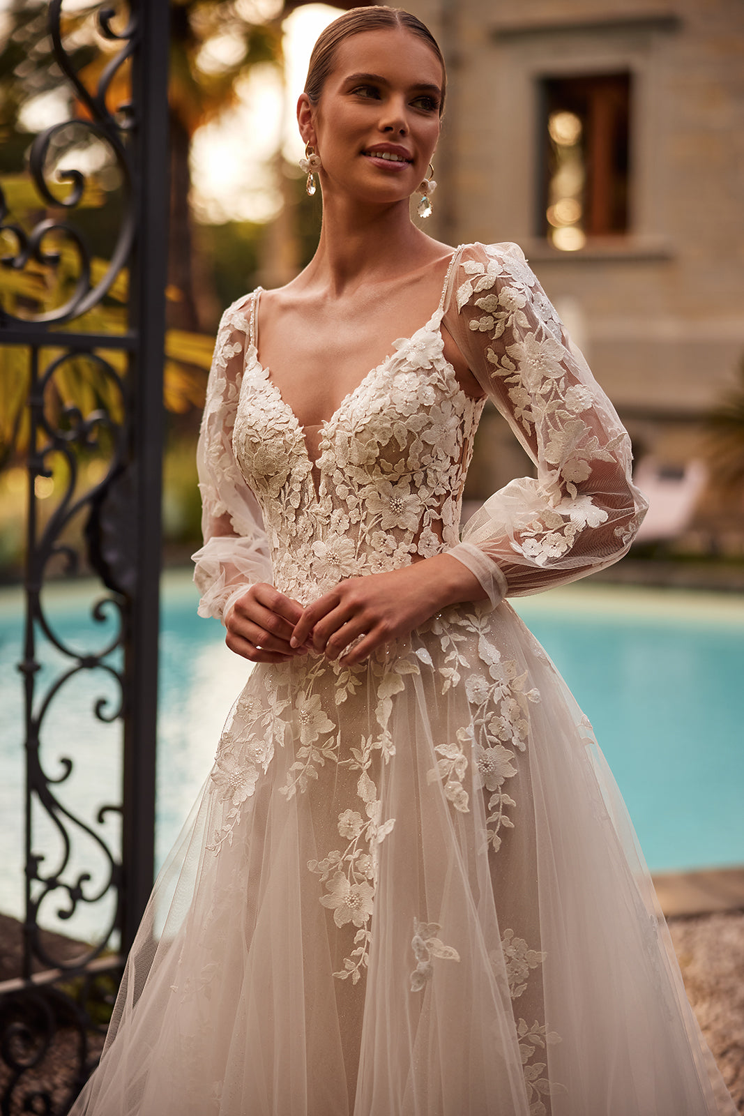 Ariana wedding dress from the front, with floral lace and long sheer sleeves