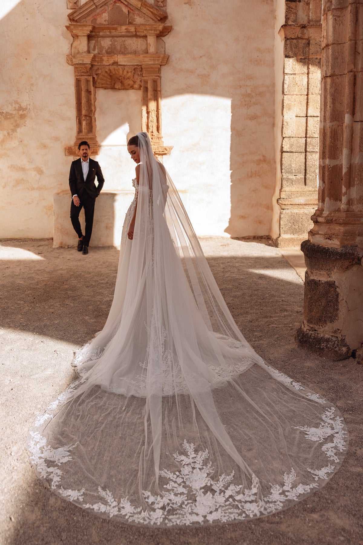 In motion, the veil of Ariella gently flows, highlighting the dress’s romantic and majestic style.