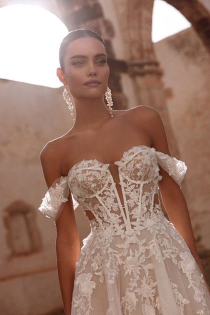 A close-up of the Ariella bodice reveals delicately placed floral lace appliqués, a defining romantic feature of the gown.