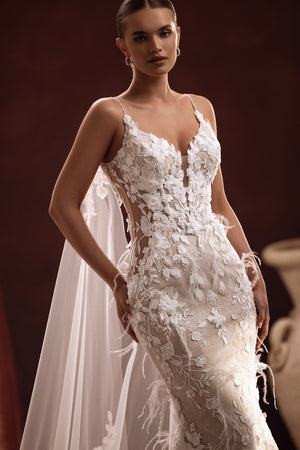 Aspasia long bridal cape with lace embroidery on the train creates a luxurious and elegant wedding day look.