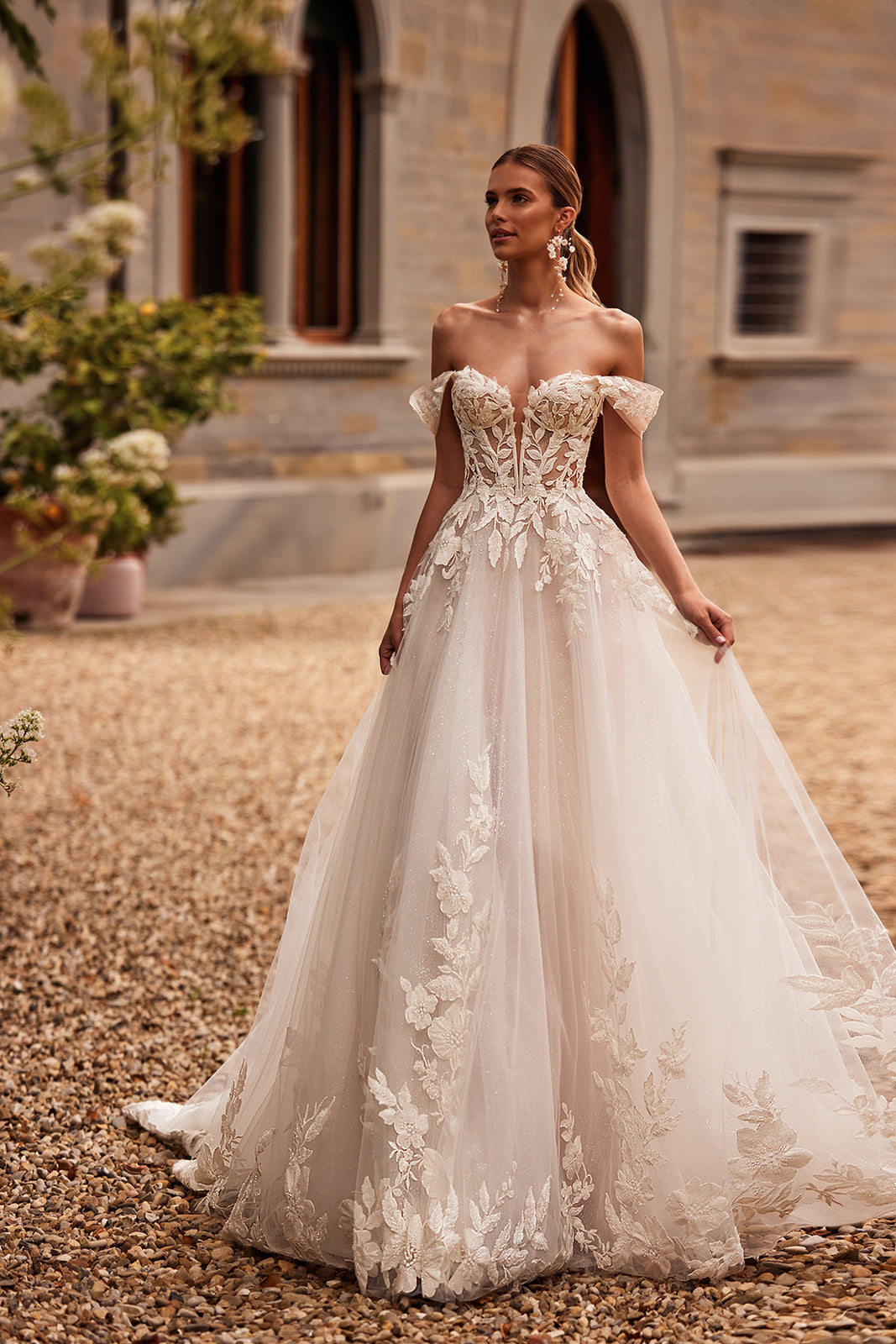 Aurora A-line wedding dress from the front, with off-the-shoulder sleeves and floral lace on tulle