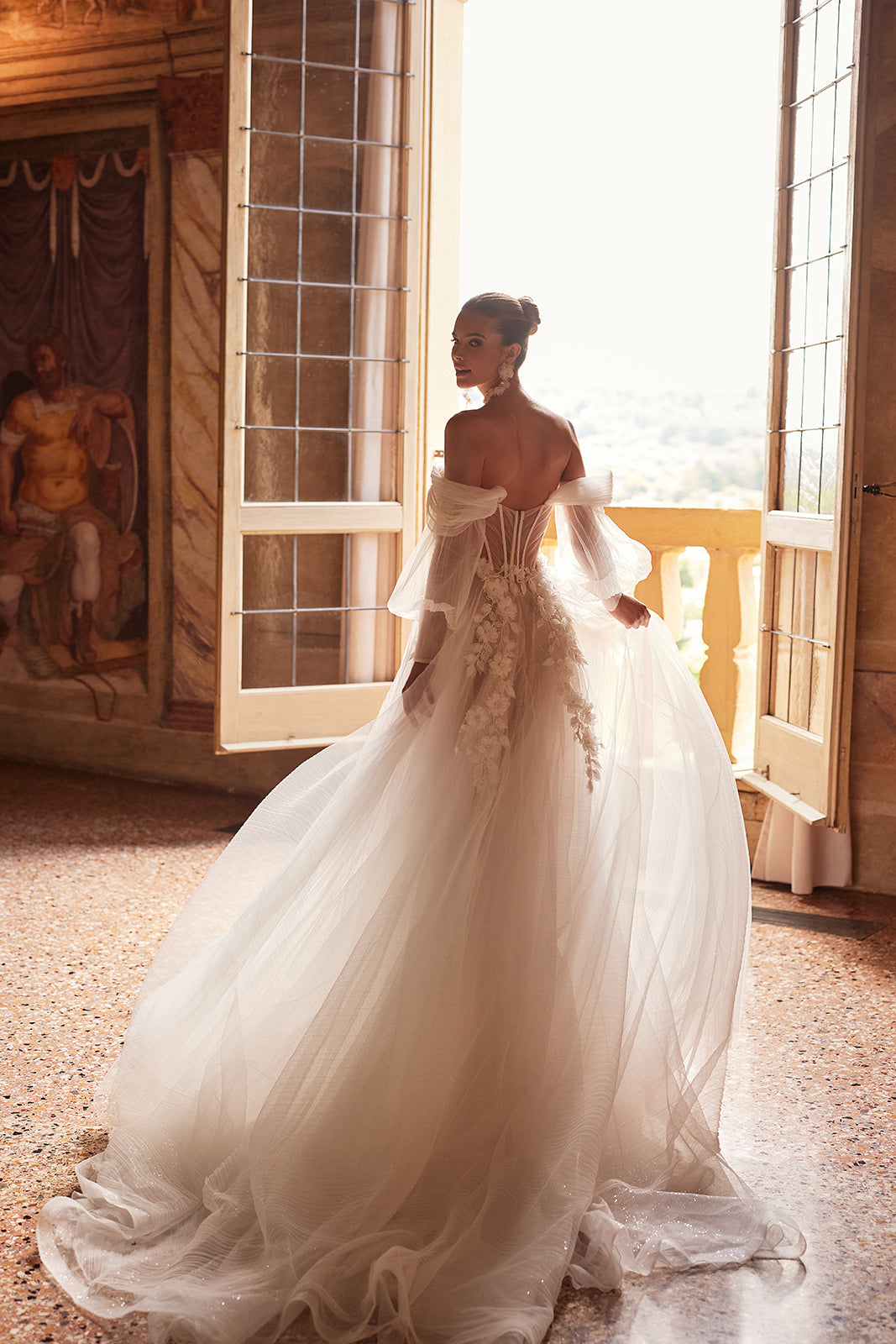 Avalon wedding dress in motion against the light, its tulle skirt and train lifting