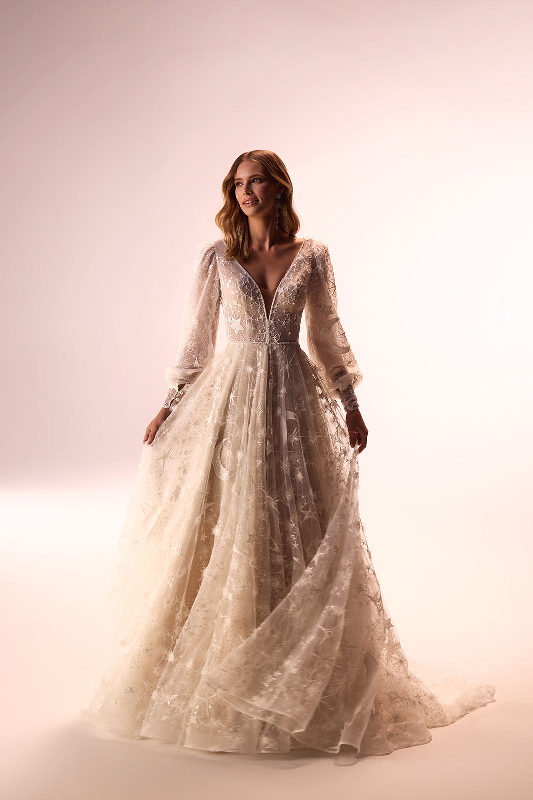 Front view of Celestia A-line wedding dress, with star-embroidered tulle and wide sleeves