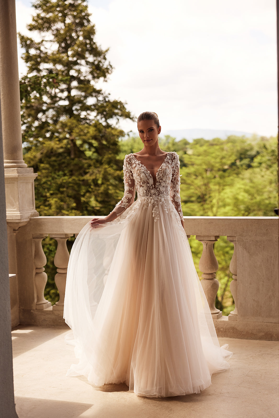 Felicia A-line wedding dress on a terrace, with a tulle skirt and lace bodice