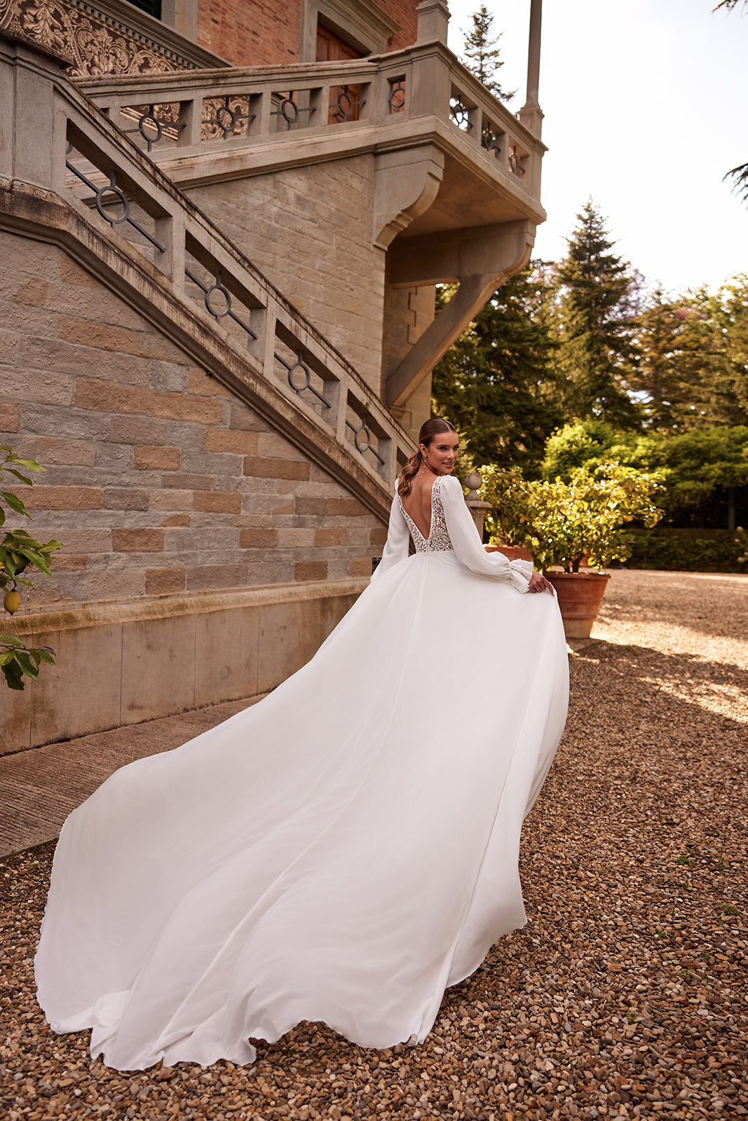 Full-length view of Hellen wedding dress, with chiffon flowing into an A-line skirt