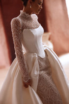 The Henriette overskirt with sparkling lace and satin train enhances the elegance of a contemporary bridal look.