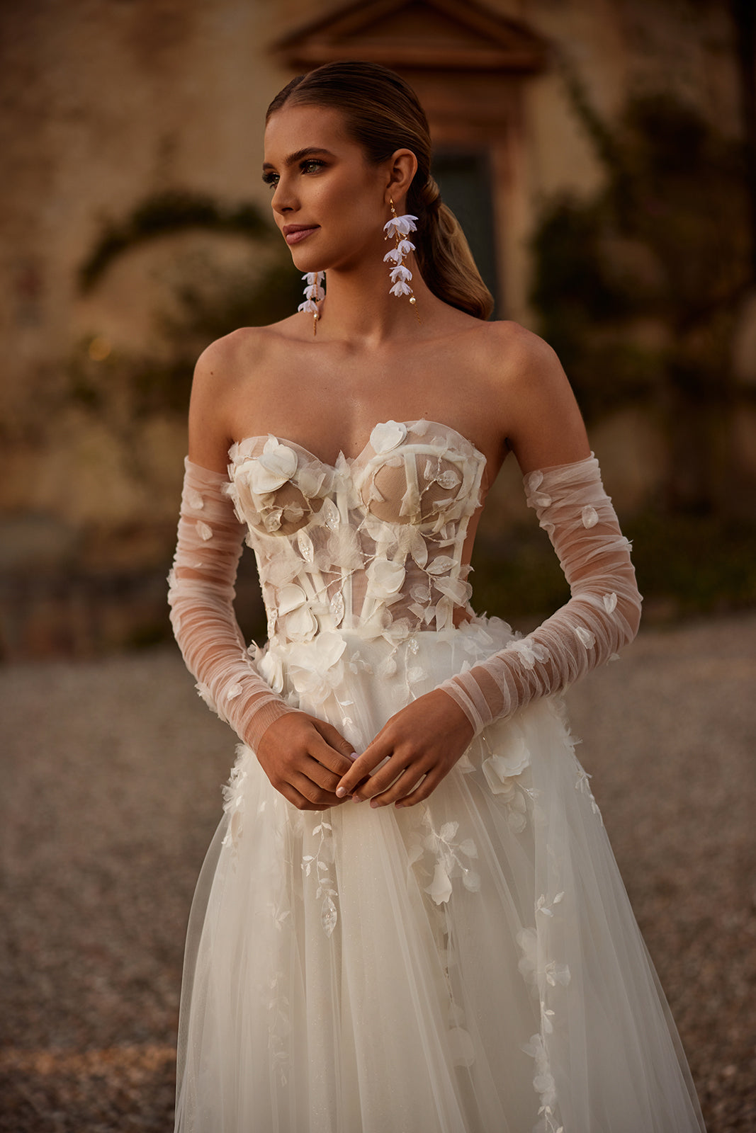 Front view of Ilimaris wedding dress, with visible corset boning and off-the-shoulder sleeves