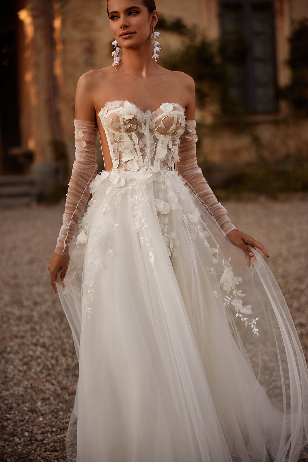 Ilimaris wedding dress in close-up, with a sheer floral corset and tulle sleeves