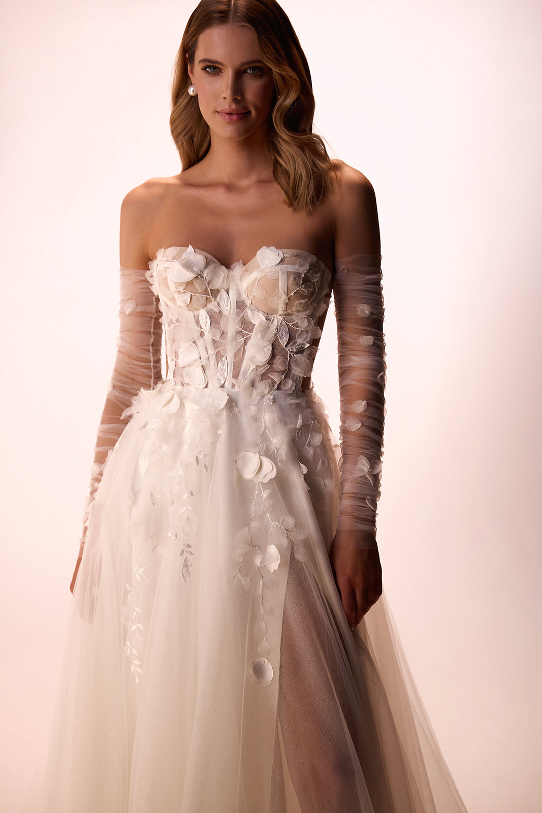 In the studio, Ilimaris wedding dress with floral appliqués on the bodice and tulle sleeves