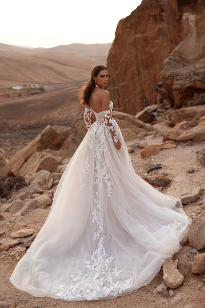 The Nabila bridal gown with a lace corset and open back combines delicate femininity with timeless bridal charm.
