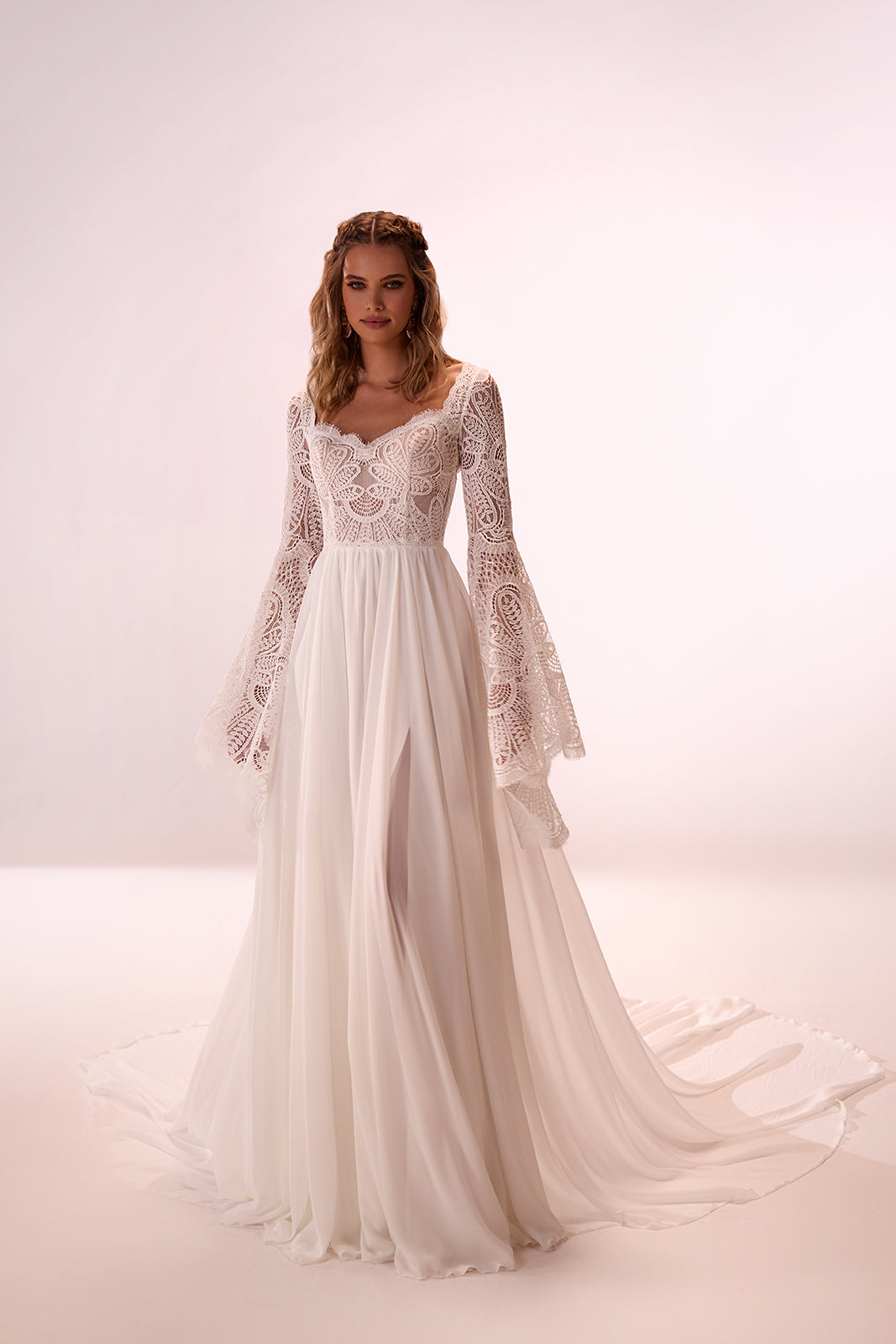 Front view of Saskia, a boho lace wedding dress with long sleeves