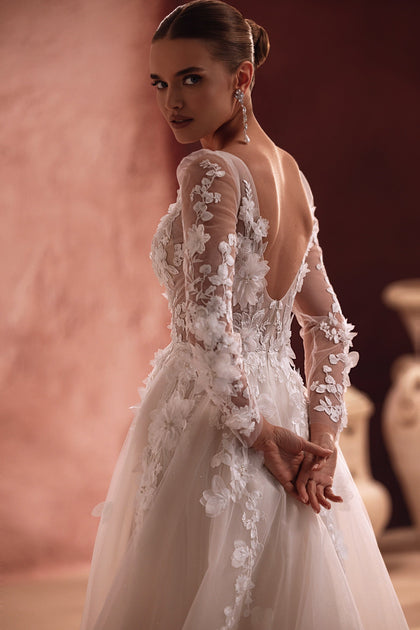 Close-up on Semiramida’s embroidery and lace applique work reveals exquisite craftsmanship and luxurious detail.