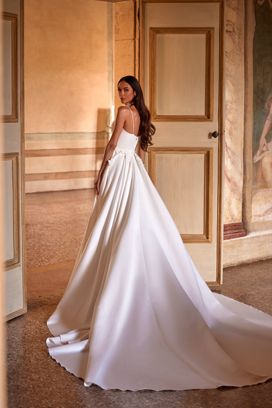 Back view of Seraphine with smooth satin falling into the skirt