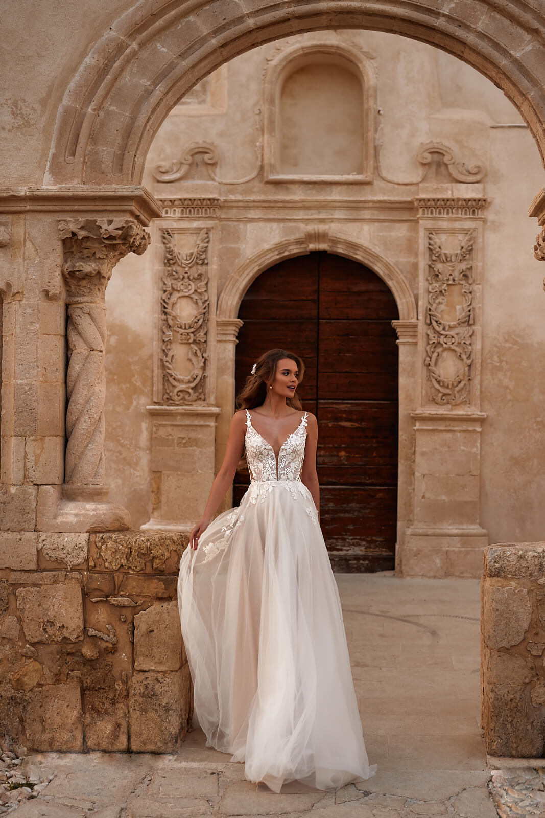 Full-length view of Avril A-line wedding dress, showing floral lace and side cut-outs