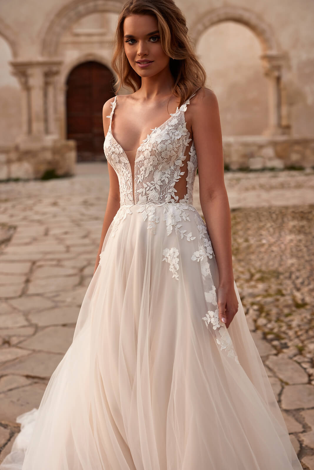 Avril A-line wedding dress with matte floral lace across the bodice and a blush tulle skirt