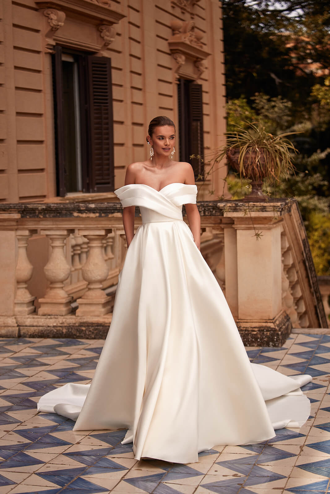 From behind, Bona wedding dress with an open back and its train spread out