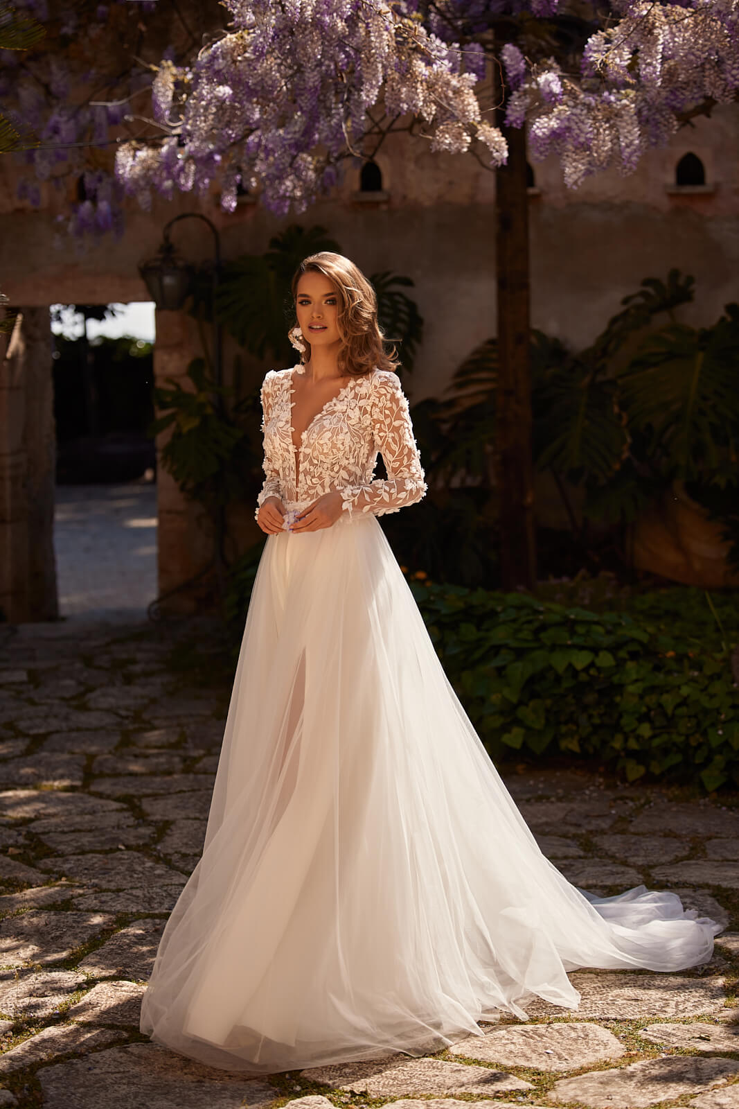 Front view of Ida A-line wedding dress, with long sleeves covered in leaf lace