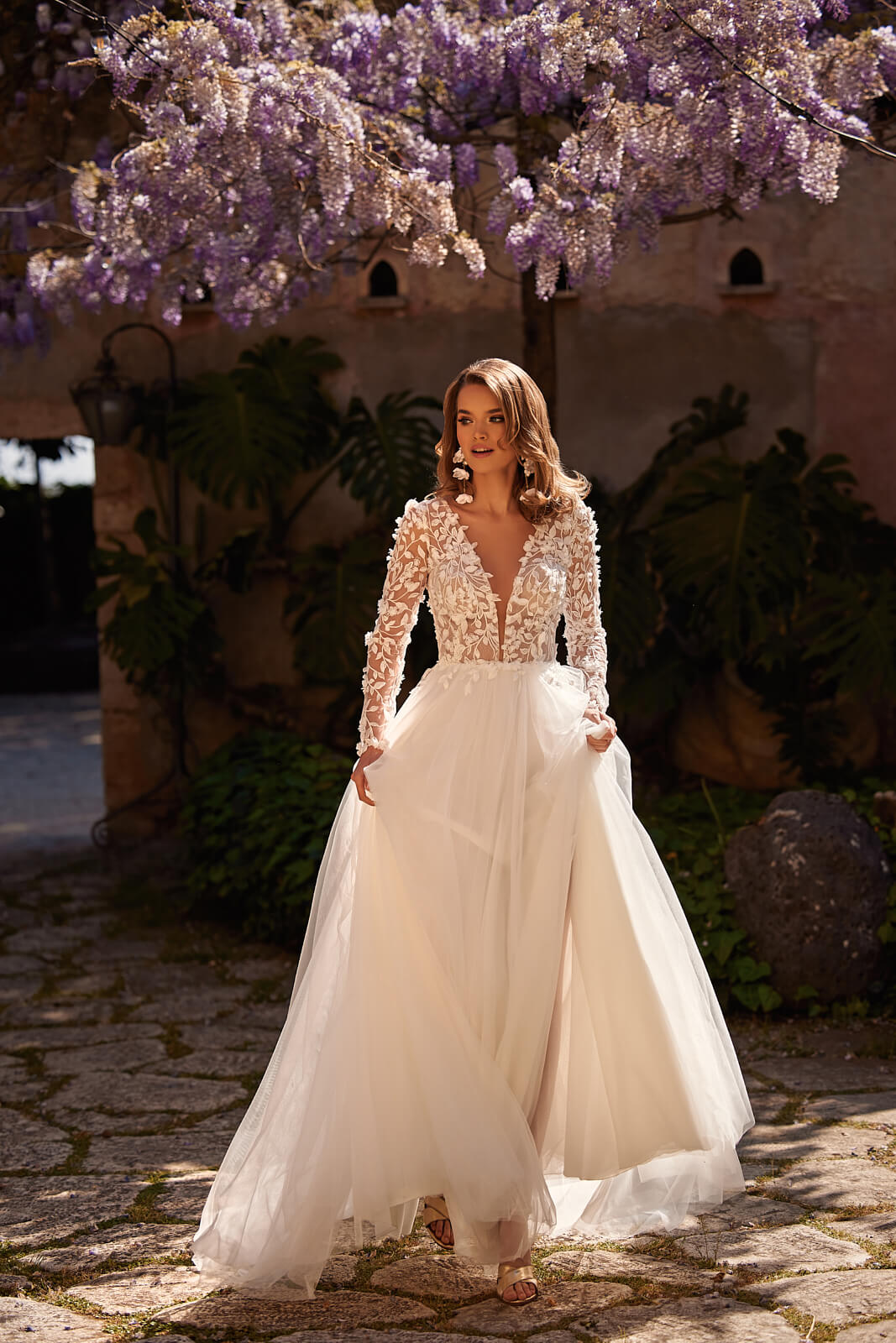 Side view of Ida wedding dress, with a concealed slit in the tulle skirt and a trailing hem