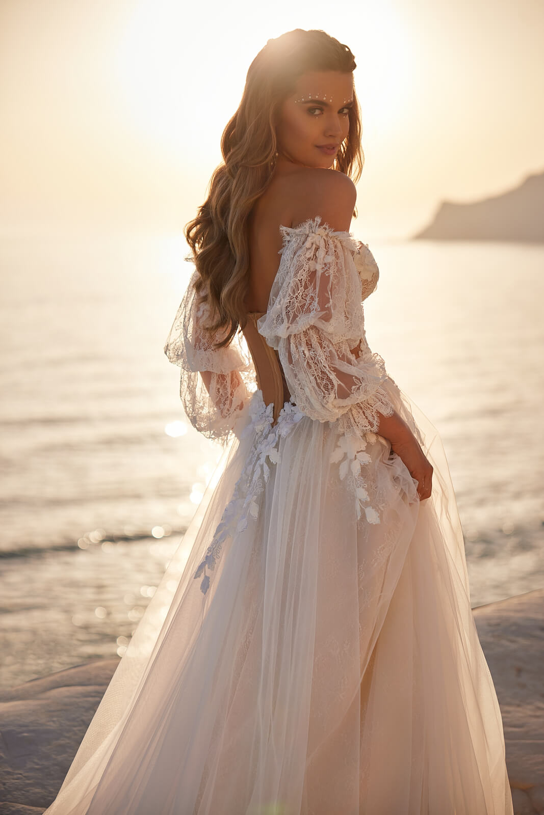 Sievi in profile, showing an open back and floral lace above the full tulle skirt