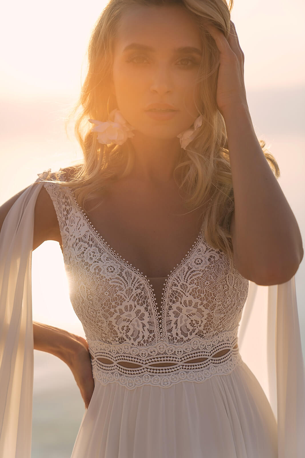 Close-up of Atena wedding dress, showing the V-neck lace bodice and openwork waistband