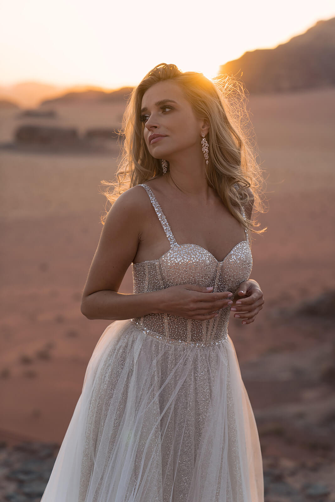 Inca wedding dress against the desert sun, showing fine beaded straps and a sweetheart neckline
