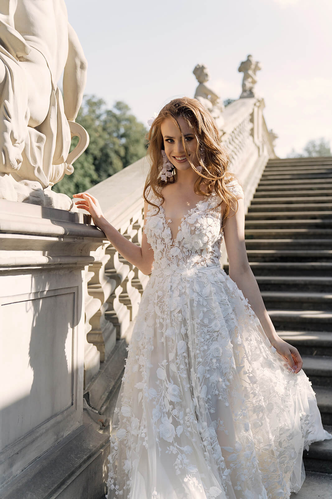 Azalea A-line wedding dress on palace steps, with lace and a long train