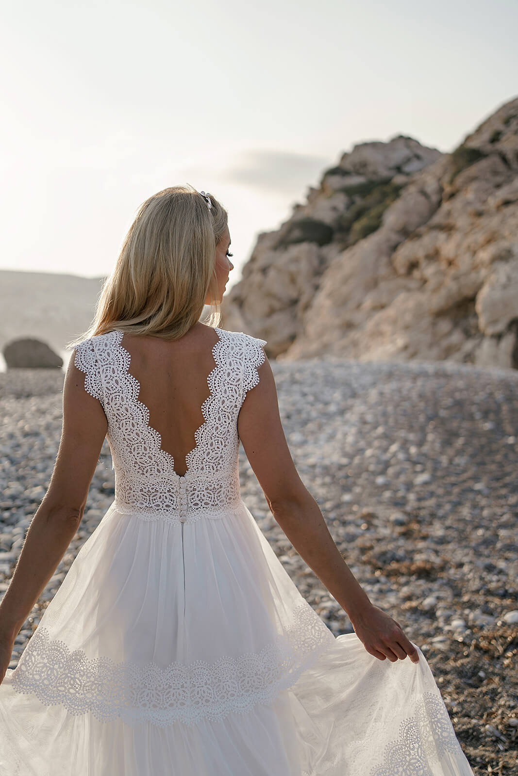 From behind, Lidia wedding dress with a deep lace-edged back above the skirt