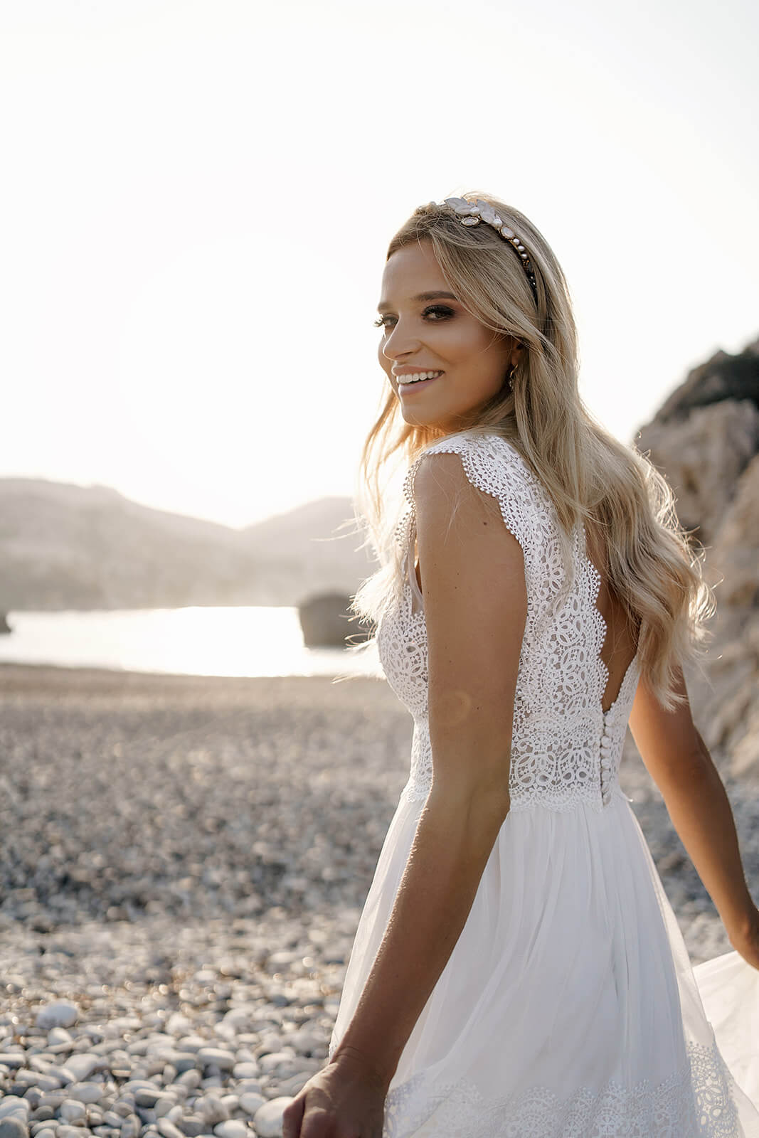 Three-quarter back view of Lidia wedding dress, showing lace and broad shoulder straps