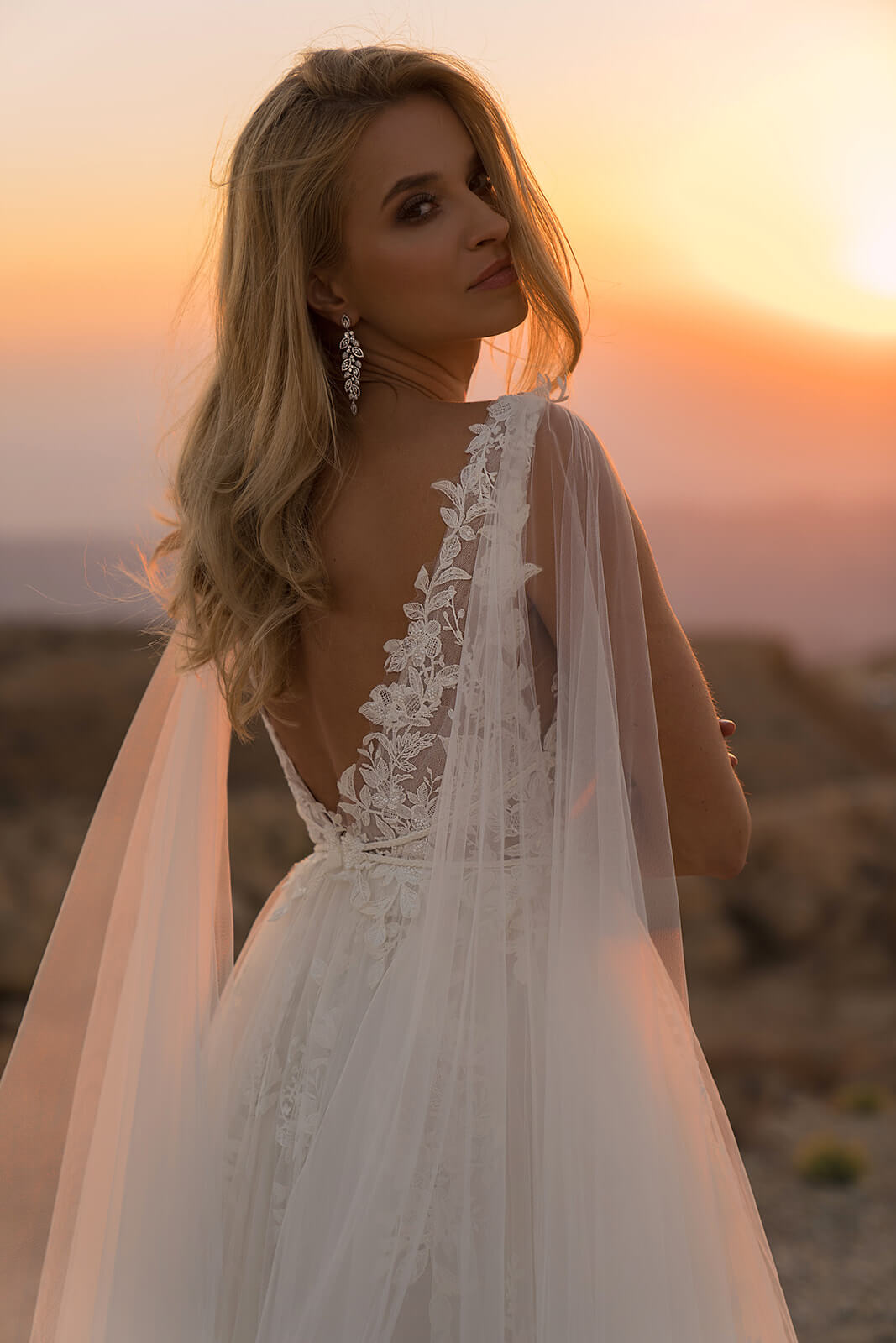 Linda wedding dress in rear close-up, with lace edging the open back beside its tulle cape