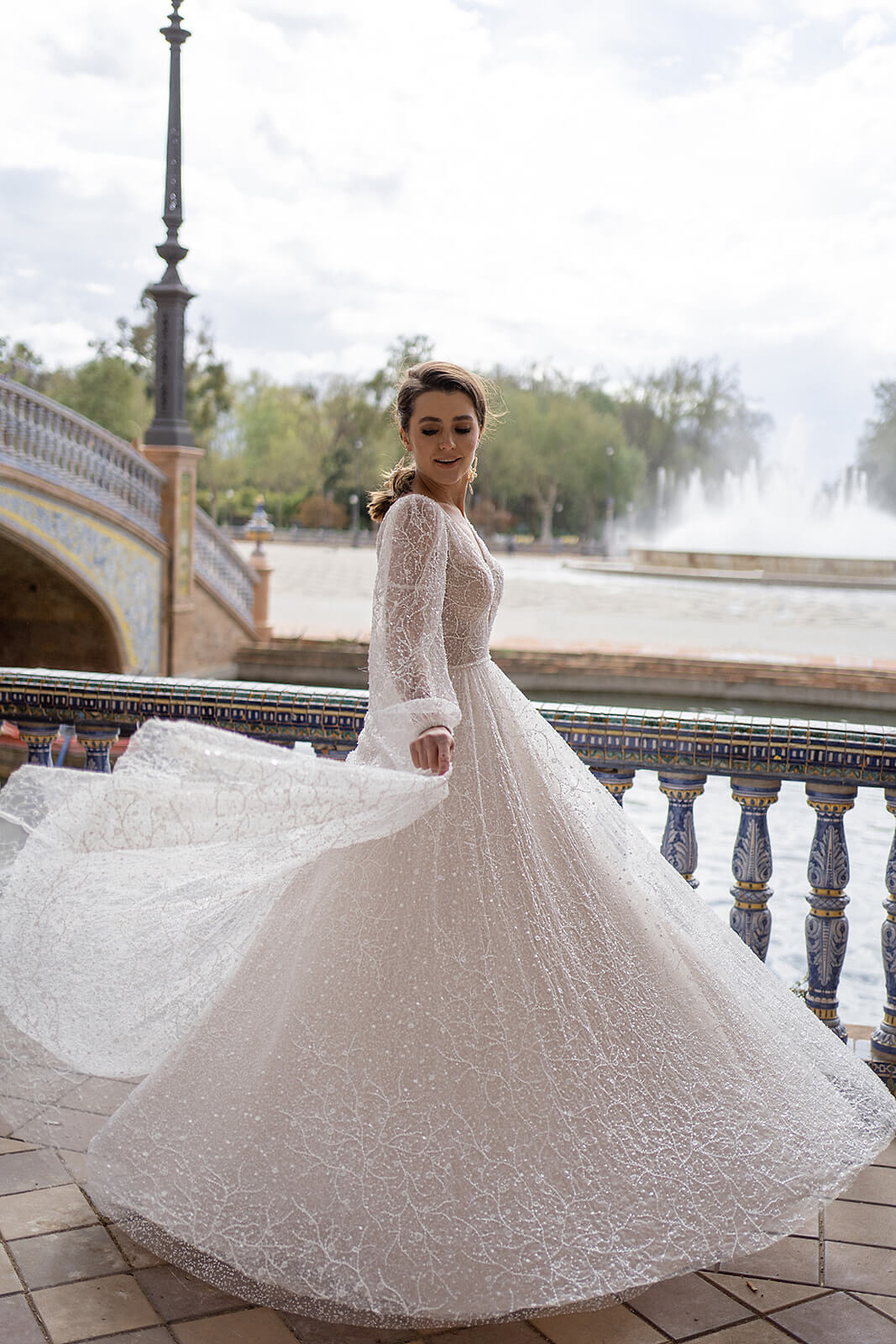Front view of Suri with a deep neckline and sheer puff sleeves