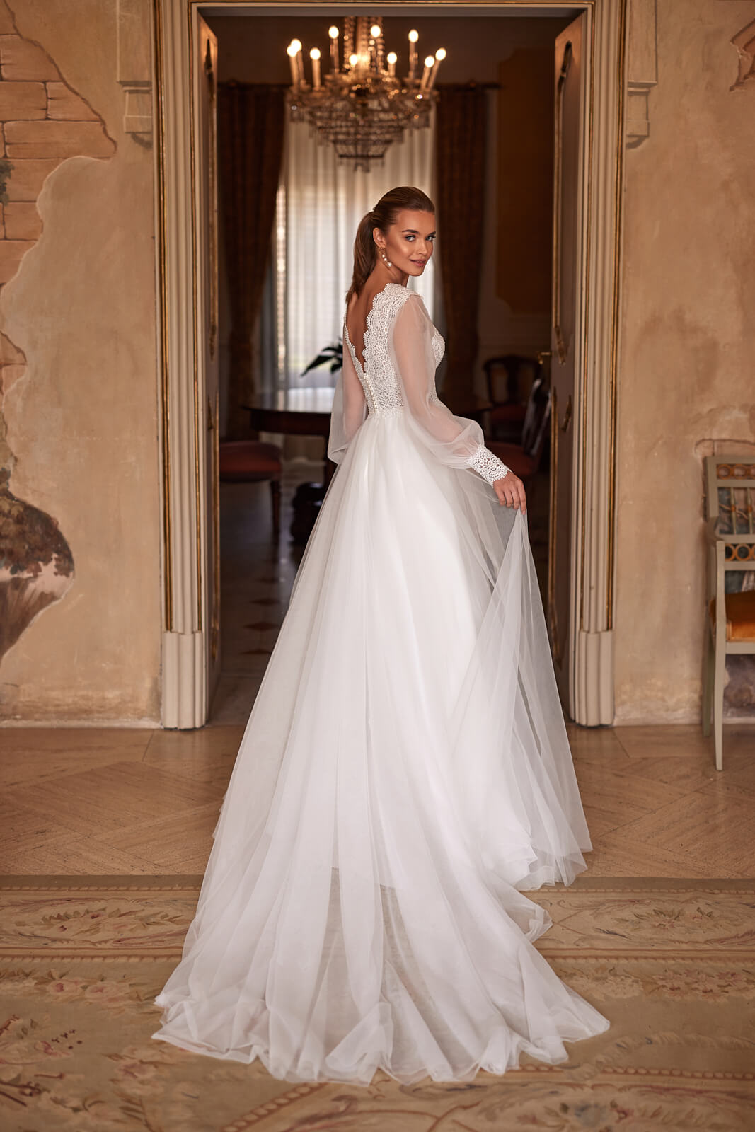 Wedding dress Eleni – A-line wedding dress with long sleeves by DAMA Couture.