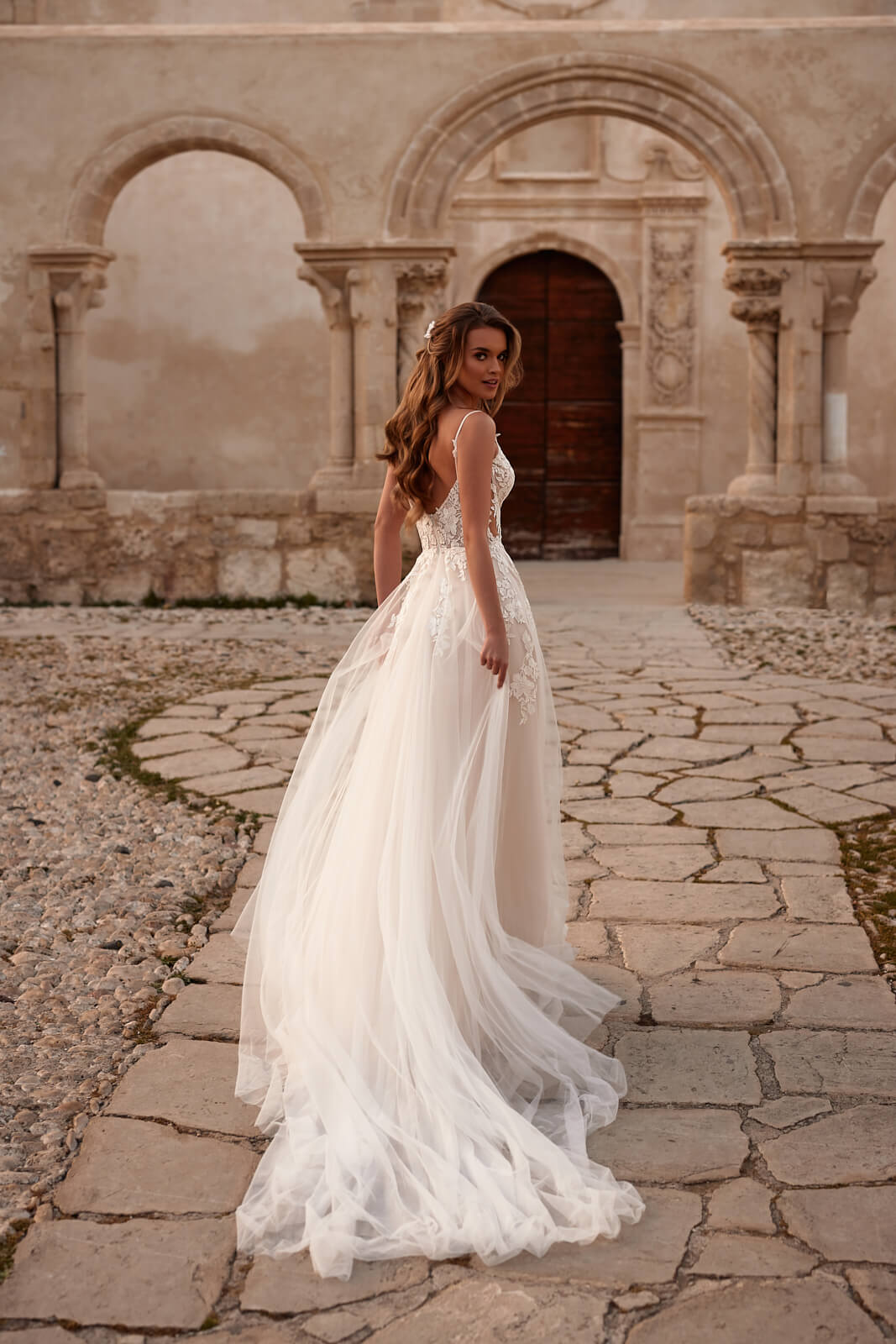From the front, Avril wedding dress with a narrow V neckline and fine lace straps