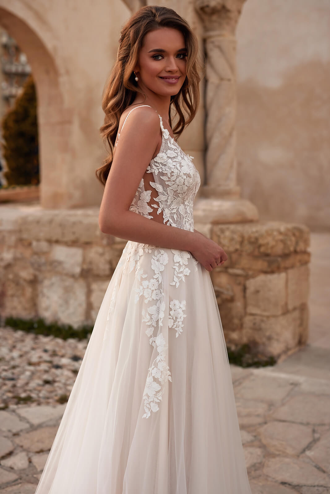 Back view of Avril wedding dress, with an open back above a wide blush and beige tulle skirt