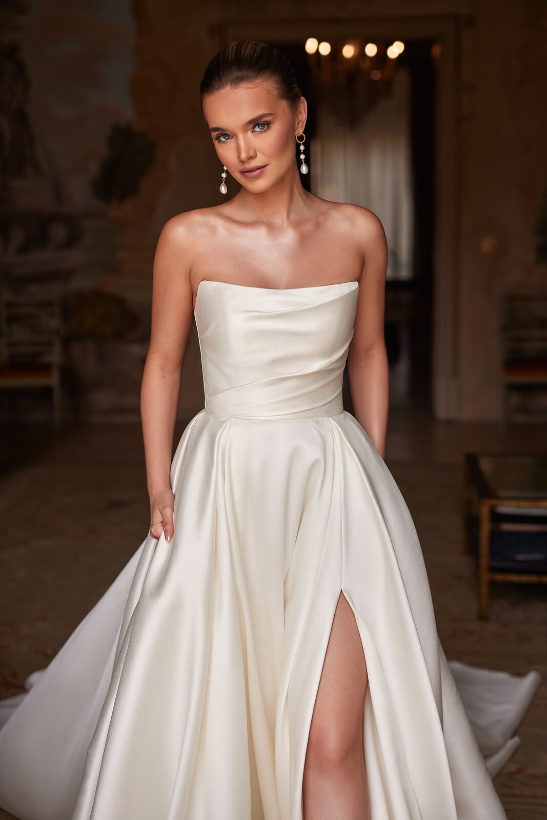 Front close-up of Madelaine wedding dress, showing the draped strapless satin bodice