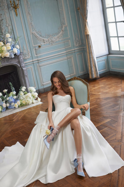 Alizee wedding dress – a folded strapless neckline and draped satin skirt, DAMA Couture Something Blue 2027.
