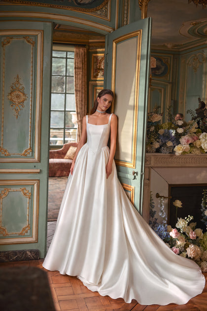 Aretuza wedding dress – a clean square neckline, slender straps and full satin skirt.