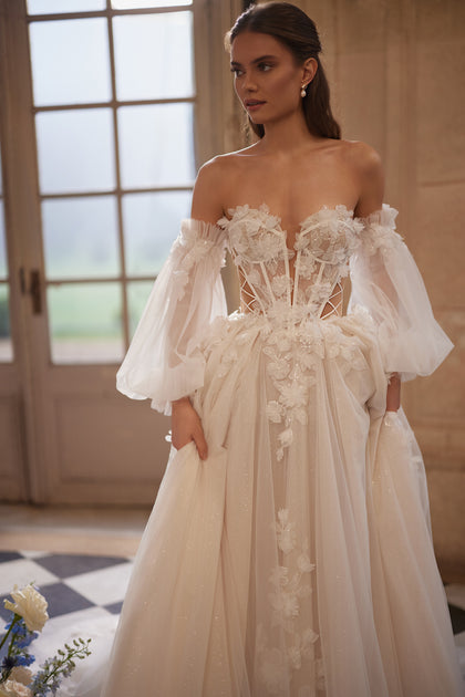 Celestine wedding dress – A-line bridal gown with an open neckline, airy off-the-shoulder sleeves and 3D florals.
