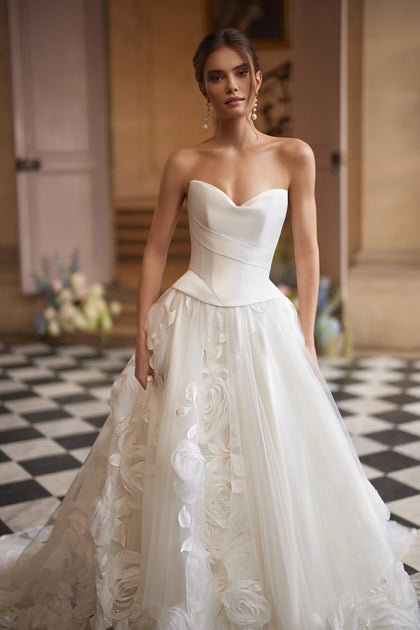 Cornellia corset + skirt – A-line bridal gown with an asymmetrically draped corset and voluminous layered skirt.