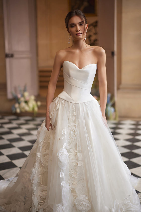 Cornellia corset + skirt – A-line bridal gown with an asymmetrically draped corset and voluminous layered skirt.