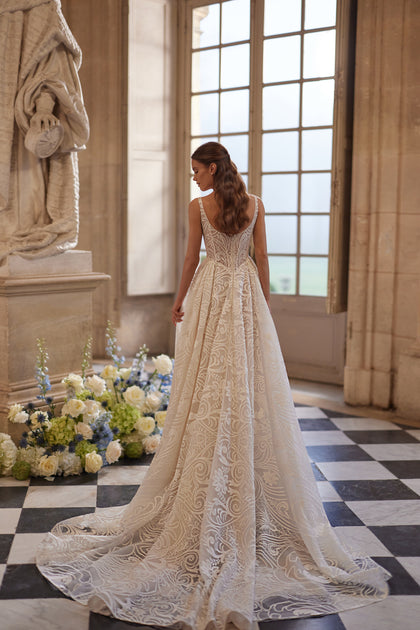 Frigga wedding dress – slender straps, a squared neckline and graphic lace ball skirt.