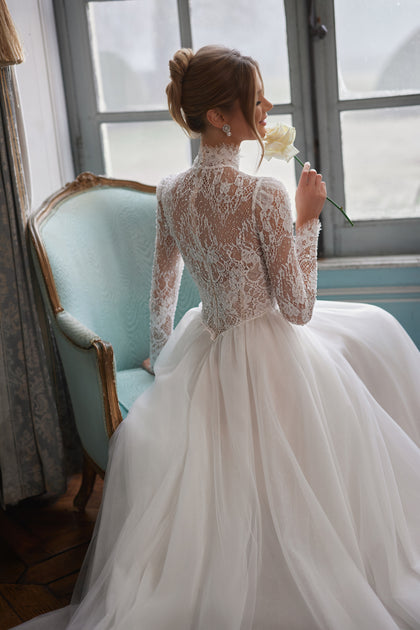 Tonia wedding dress – a high neckline and long sheer lace sleeves.