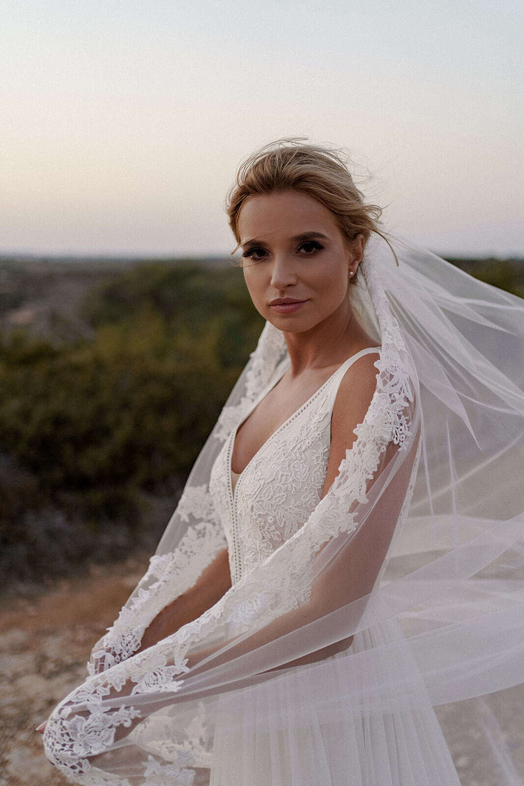 Side view of Cathedral veil with lace, pinned to the bride's hair