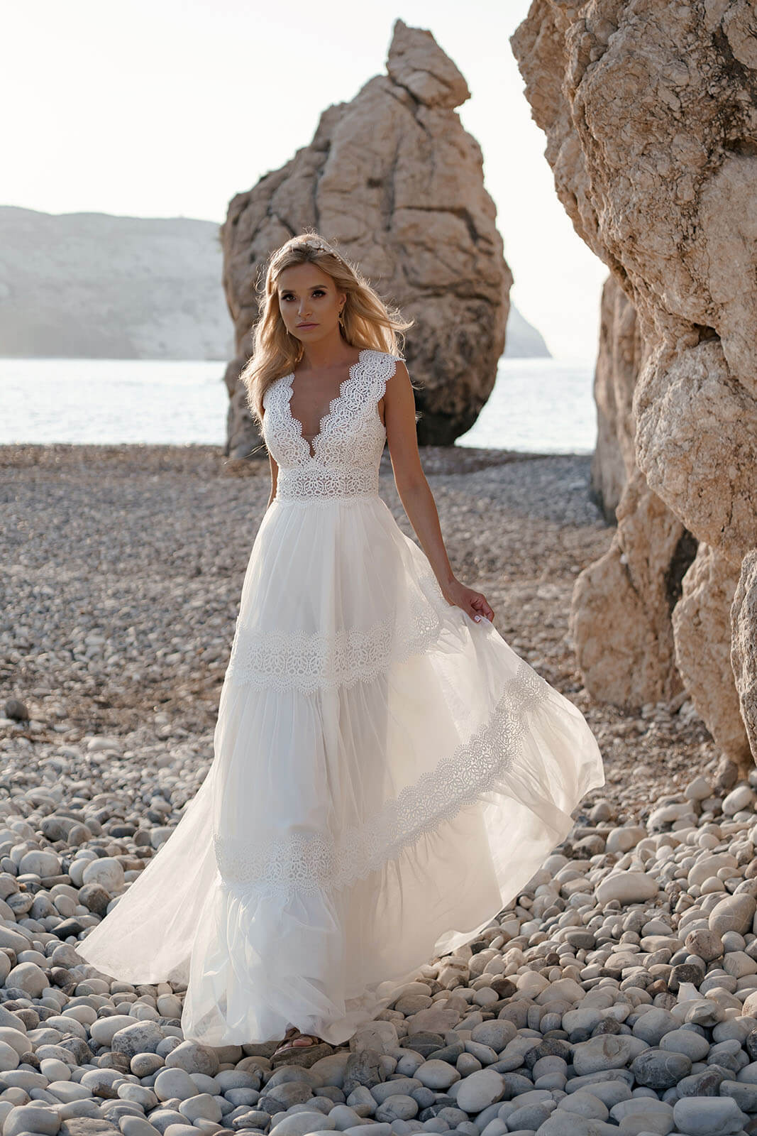 Front view of Lidia A-line wedding dress, with a lace V neckline and flowing skirt