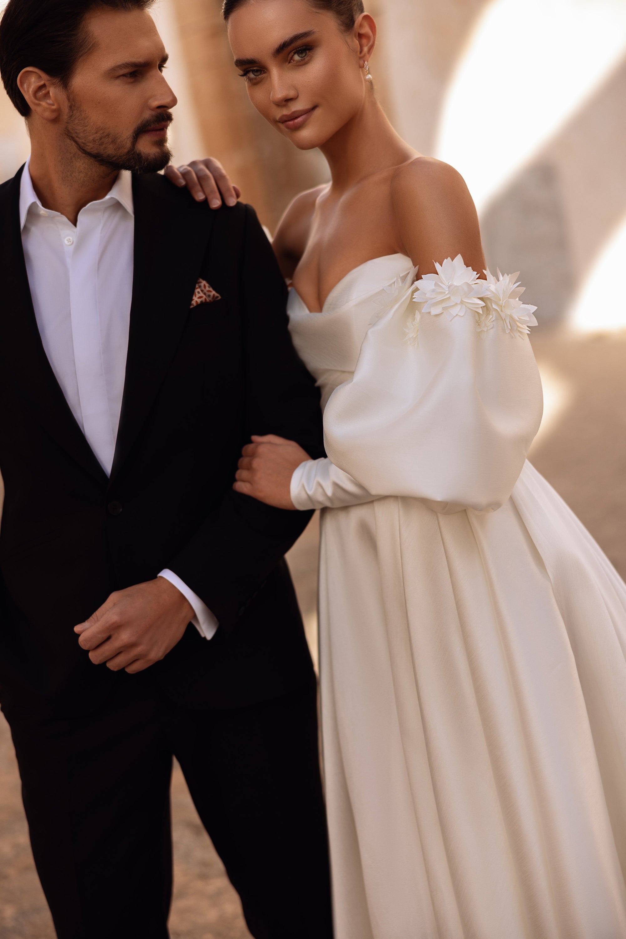 Romantic satin wedding gown Anika with sweetheart neckline and voluminous skirt glowing under natural sunlight.