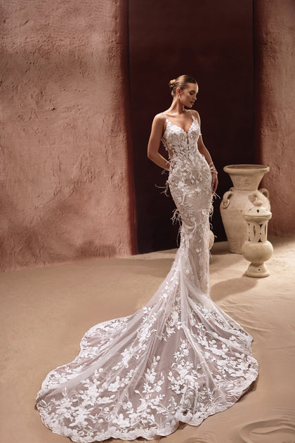 The Aspasia bridal gown in mermaid style features lace embroidery and feather accents for a modern luxury look.