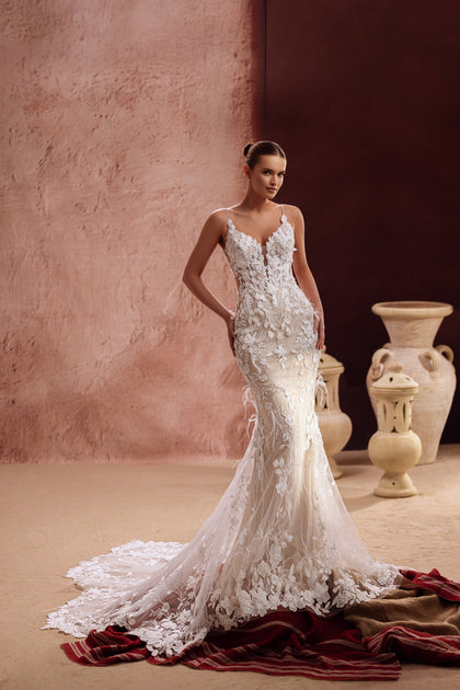 The Aspasia wedding dress combines a floral lace bodice with a flowing tulle train for a dreamy, romantic bridal look.