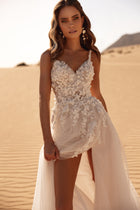 The Aviva bridal gown with a delicate lace bodice and 3D floral embroidery captures soft femininity under the desert sun.